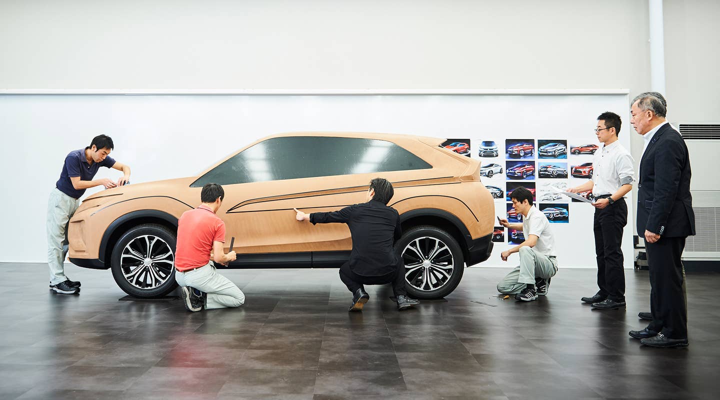 designers scuplting a car